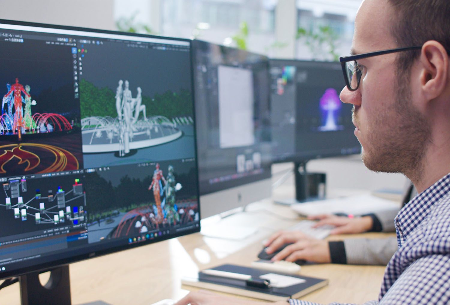 3D artist DION creating photorealistic visualizations of a project on multiple monitors