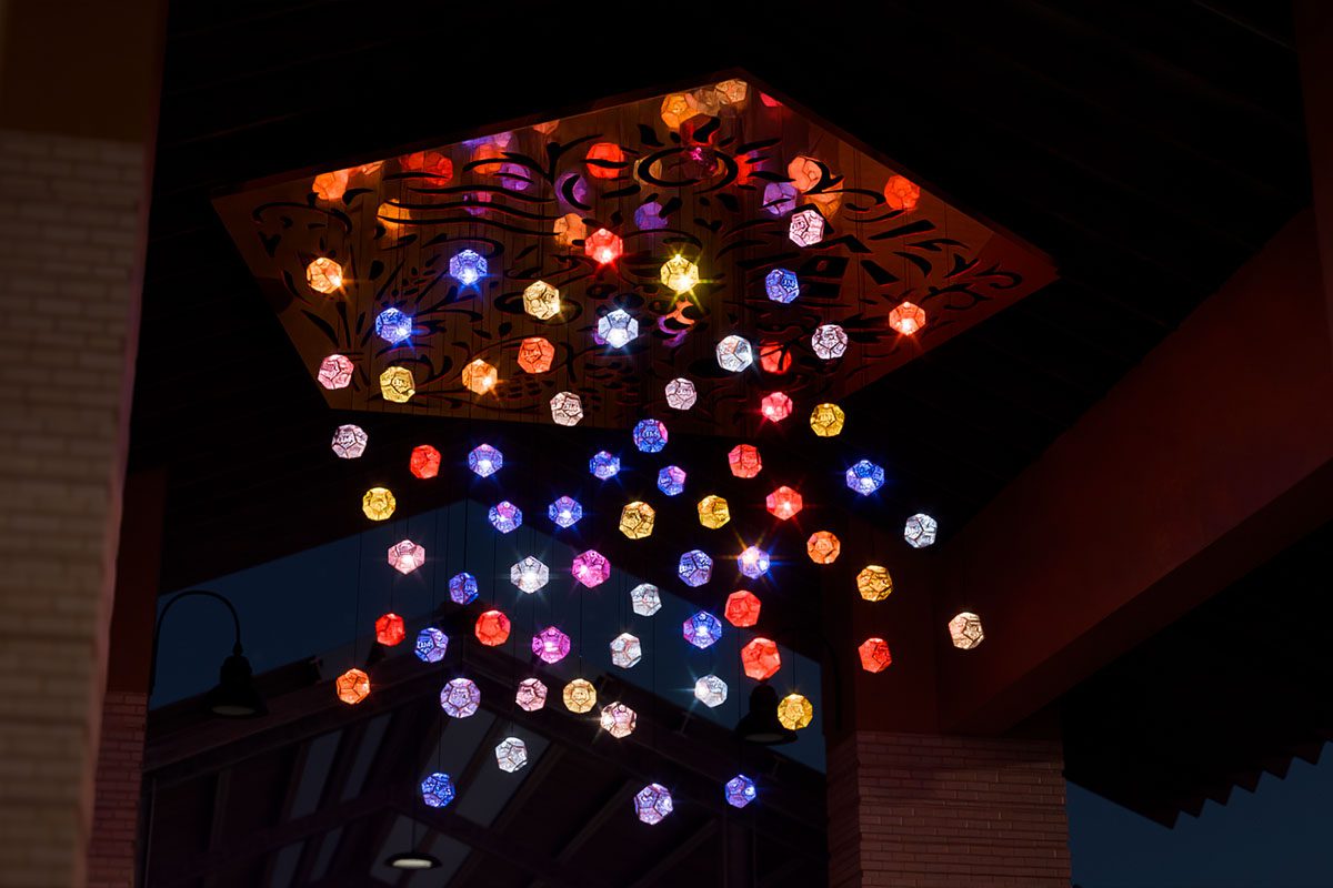 nighttime view of the Five Elements installation with all kinetic light modules illuminated
