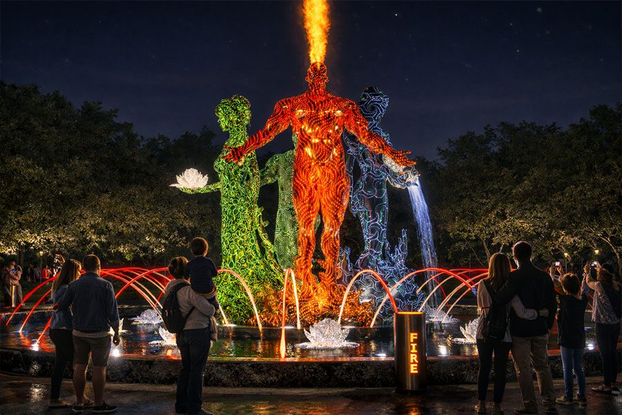 illuminated abstract human sculptures in a fountain installation